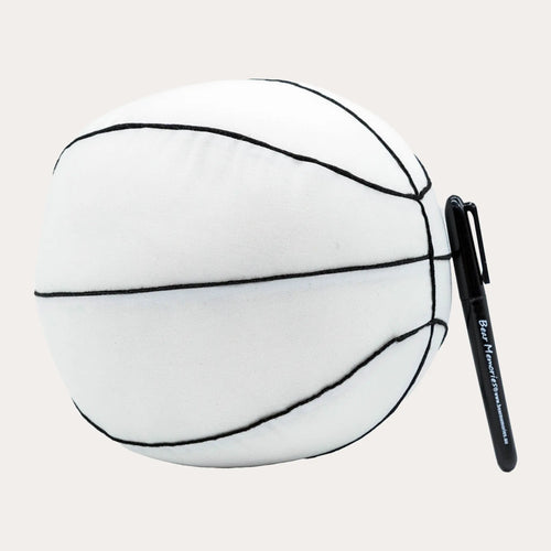 Soft white fabric signature basketball with black embroidered seam lines, shot on a plain off-white background, its smooth unprinted panels ready to be signed, with a black permanent marker clipped alongside.