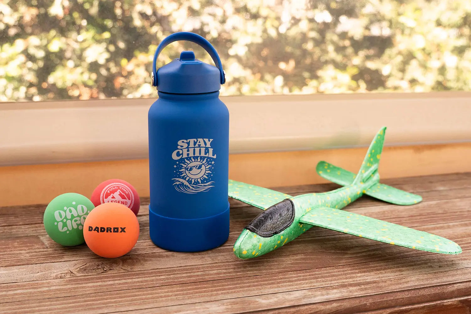 A selection of our Father's Day stall gifts featuring a "Stay Chill" drink bottle, toy plane, and Dad joke stress balls.