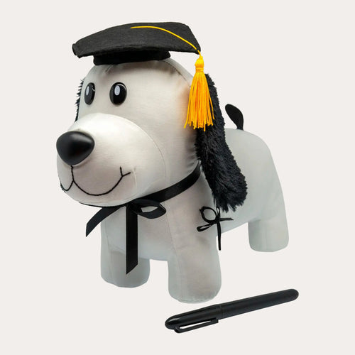 Three-quarter view of the same white plush puppy showing the fixed standing legs, black felt tail and black satin neck ribbon, with the black permanent marker laid loose beside it.