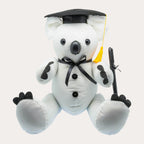 White plush signature koala sitting front-on against a plain off-white background, wearing a black felt mortarboard with a gold tassel and a black satin neck ribbon tied in a bow, with black felt claw patches, two black buttons down the front and a black permanent marker tied to one paw with ribbon.