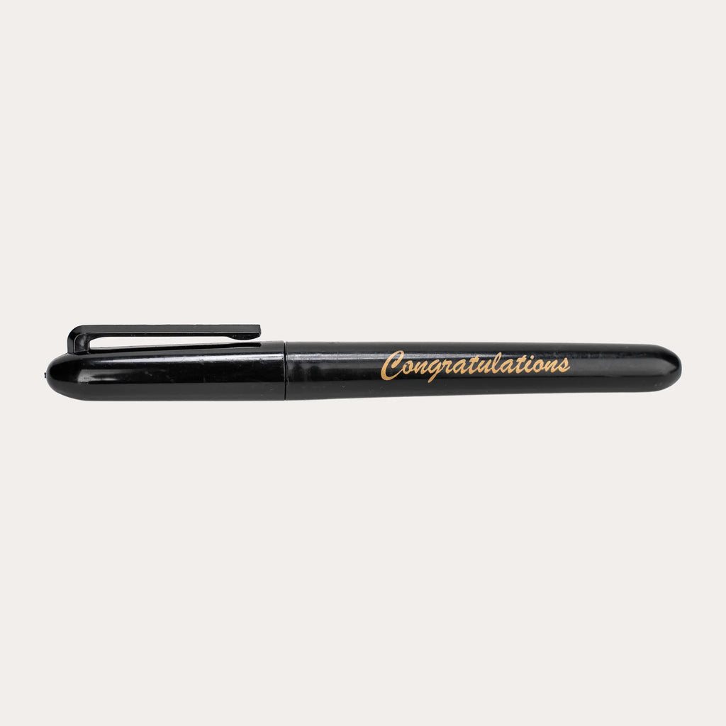 Capped black gloss permanent marker shown side on against white, printed "Congratulations" in gold italic script along the barrel, with a moulded black pocket clip and rounded ends.