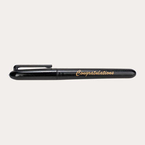 Capped black gloss permanent marker shown side on against white, printed "Congratulations" in gold italic script along the barrel, with a moulded black pocket clip and rounded ends.